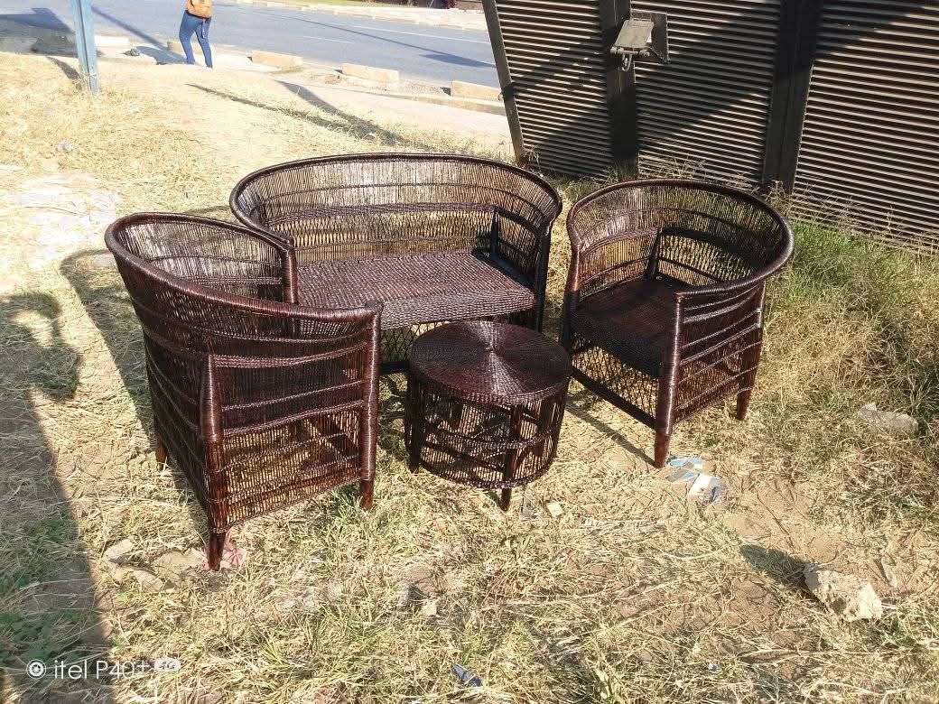 Dark brown wicker outdoor lounge set on grass