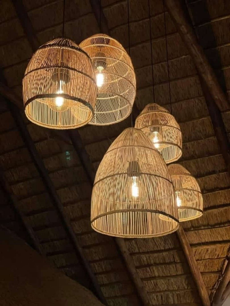 Rattan pendant lampshades hanging from thatched roof